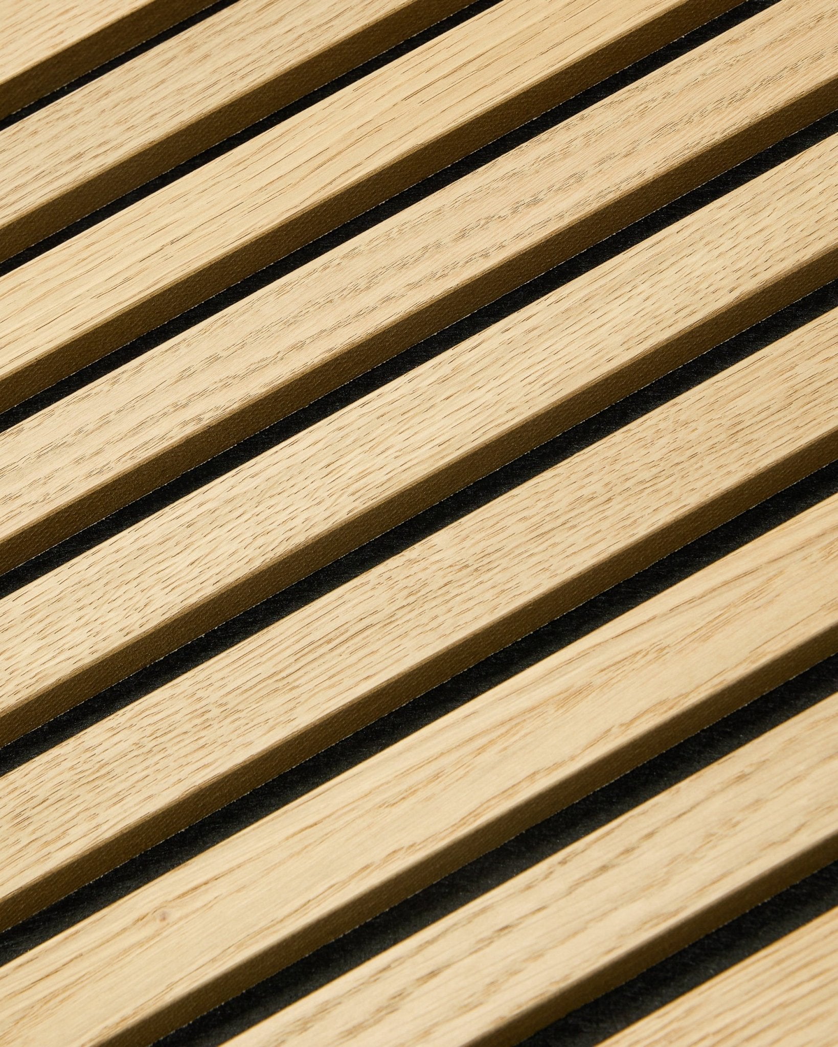 Close-up of WoodUpp Akupixel Classic Oak acoustic panel, 60x60 cm, featuring black felt gaps between oak slats in a striped Nordic design.